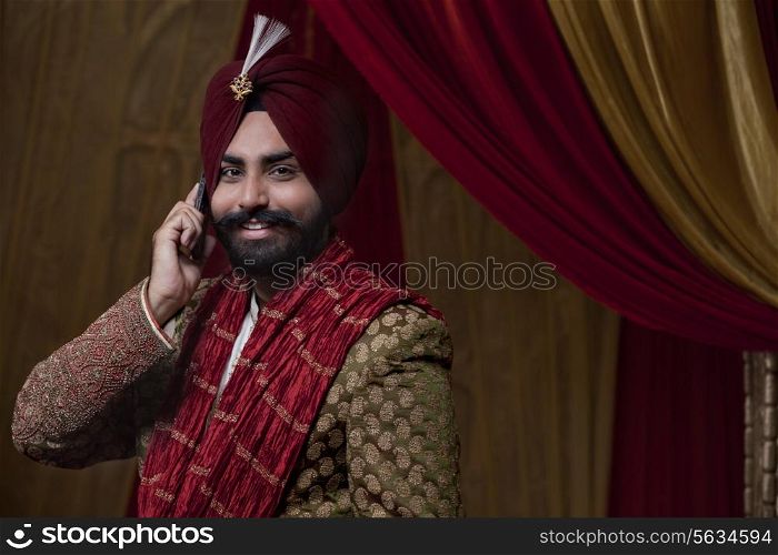 Portrait of groom having conversation on mobile phone