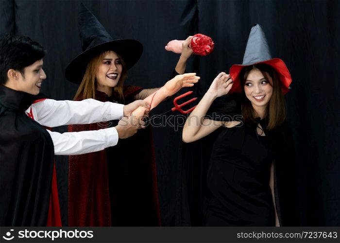 Portrait of group of friends asian young adult people wear Halloween costume to be witches and dracula character. Halloween celebrate and international holiday concept.