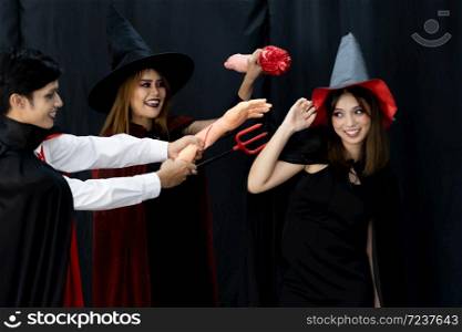 Portrait of group of friends asian young adult people wear Halloween costume to be witches and dracula character. Halloween celebrate and international holiday concept.