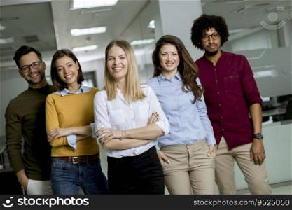 Portrait of group of young excited business people standing in office