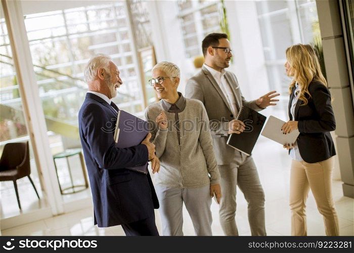 Portrait of group smiling business people standing in office