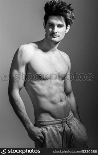 Portrait of half naked sexy body of muscular athletic man. Studio shot
