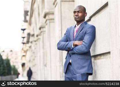 Portrait of handsome black man wearing suit in urban background