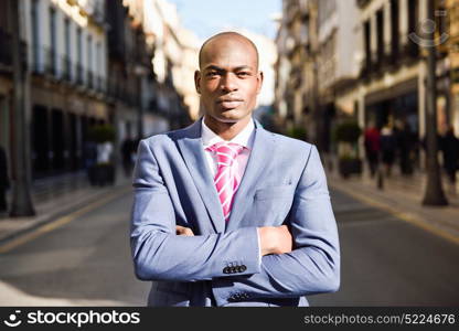 Portrait of handsome black man wearing suit in urban background