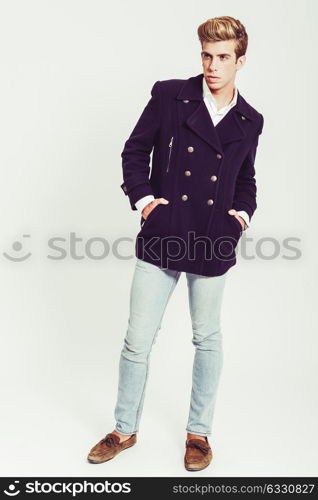 Portrait of handsome blonde man wearing jacket and blue jeans