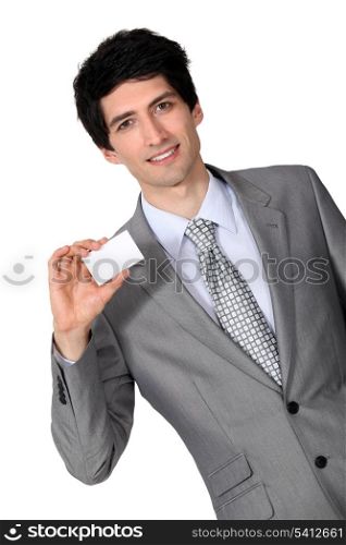 portrait of handsome businessman holding business card