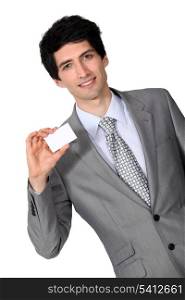 portrait of handsome businessman holding business card
