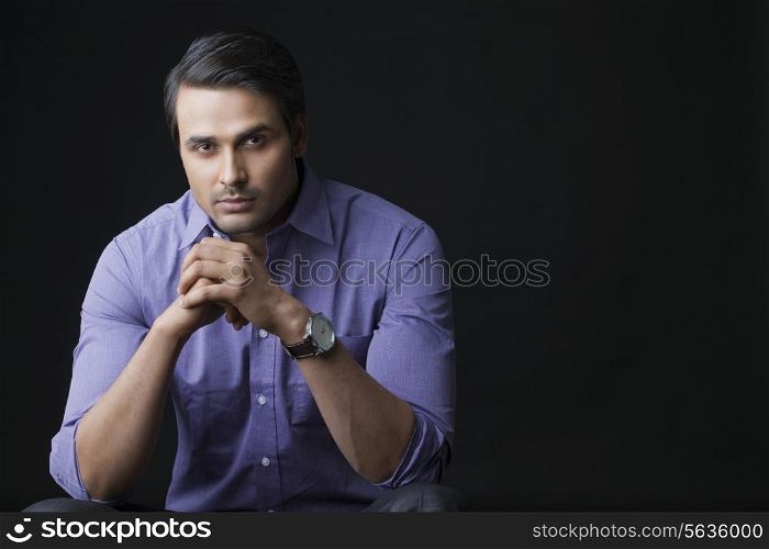Portrait of handsome businessman over black background