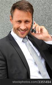 Portrait of handsome businessman talking on mobile phone