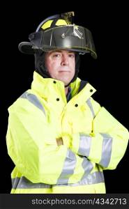 Portrait of handsome firefighter taken against a black background.