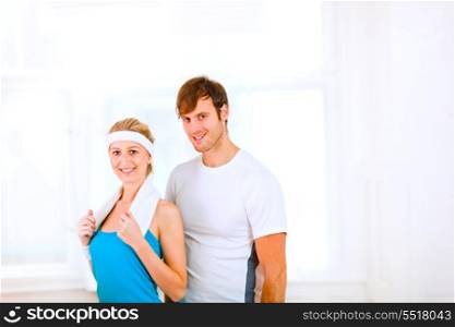 Portrait of handsome guy and pretty girl in sportswear with towel&#xA;