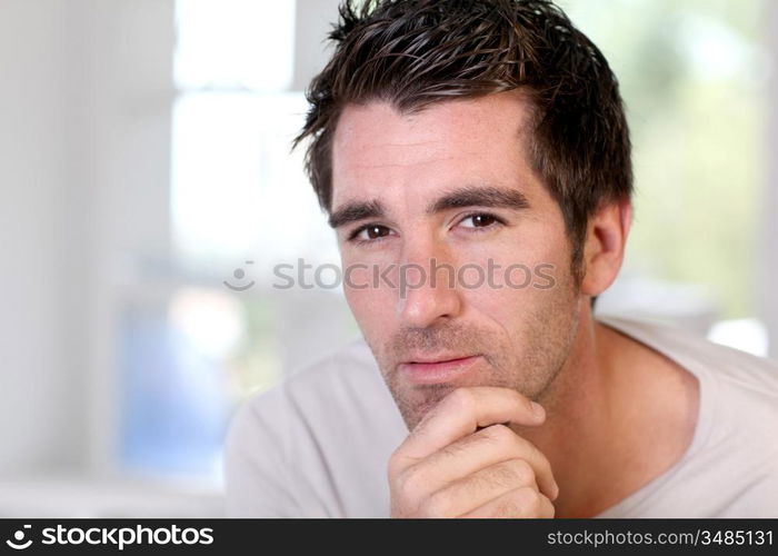 Portrait of handsome guy relaxing at home