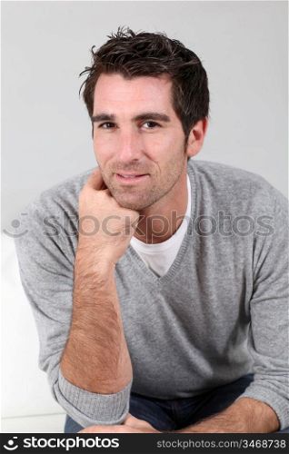 Portrait of handsome guy with hand on chin