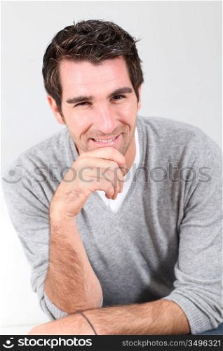 Portrait of handsome guy with hand on chin