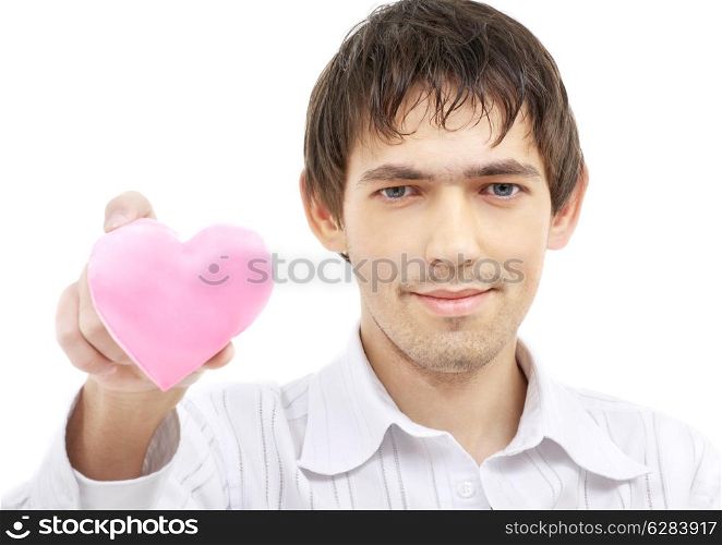 portrait of handsome man giving pink heart-shaped pillow