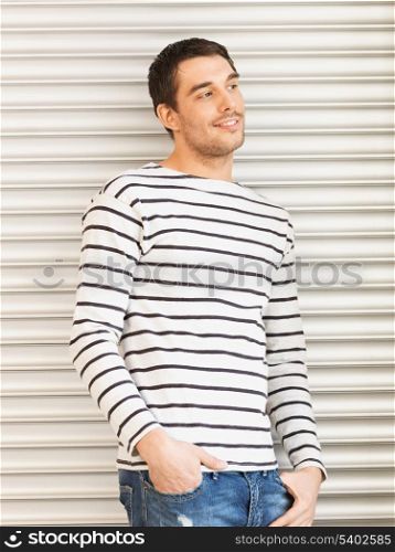 portrait of handsome man in casual clothes leaning to wall