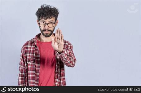 Portrait of handsome man making stop gesture with his palm. Serious man making stop sign with his palm. concept of person doing stop on isolated white background