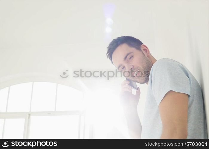 Portrait of handsome man on call at home