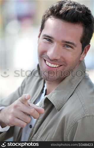 Portrait of handsome man pointing at camera