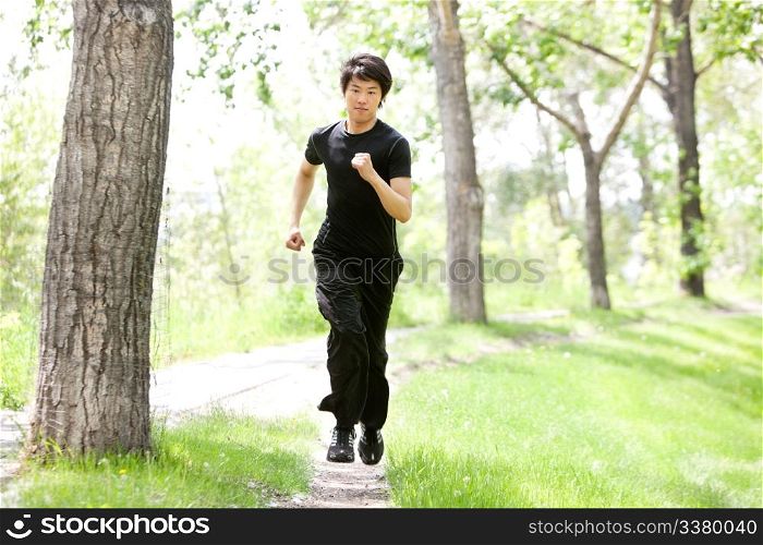 Portrait of handsome man running against blur background