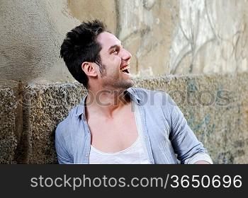 Portrait of handsome man smiling in urban background