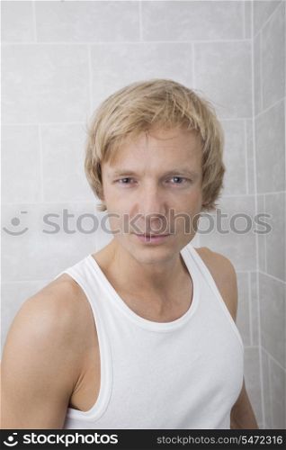 Portrait of handsome man standing in bathroom