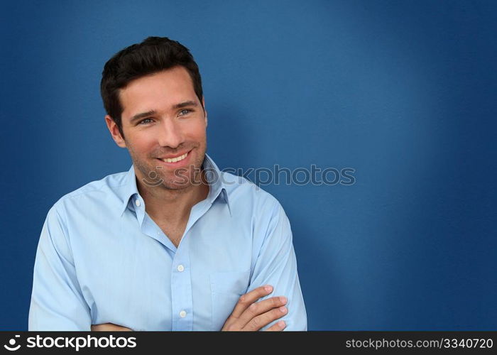 Portrait of handsome man standing on blue background