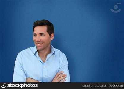 Portrait of handsome man standing on blue background