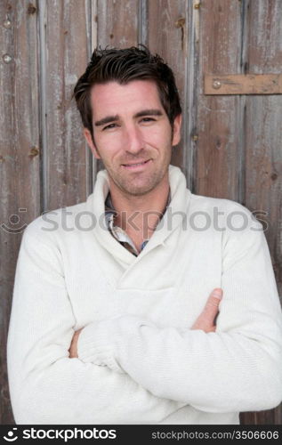 Portrait of handsome man standing on wooden door