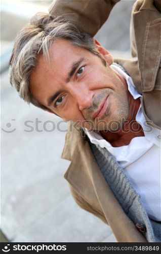 Portrait of handsome mature man in town