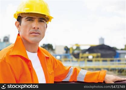 Portrait of handsome mid adult man wearing protective workwear at construction site