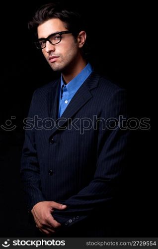 portrait of handsome model looking in isolated black background