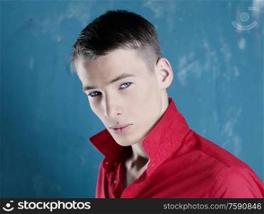 Portrait of handsome stylish man in a bright red shirt