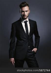 Portrait of handsome stylish man in elegant black suit