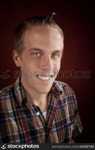 Portrait of handsome young blonde man in plaid shirt