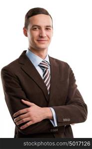 Portrait of handsome young business man standing with hands folded and smiling on white background