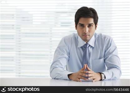 Portrait of handsome young businessman sitting in office