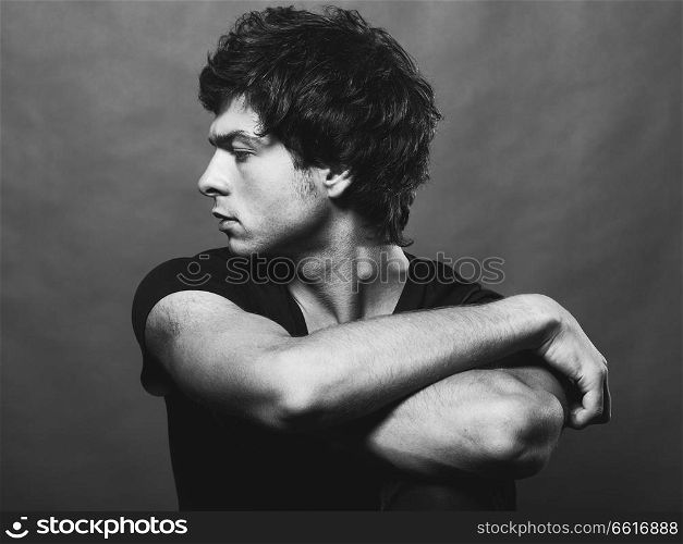 Portrait of Handsome Young Man. A Men Posing on a Gray Background. Black And White Photo