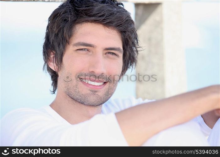 portrait of handsome young man by sea