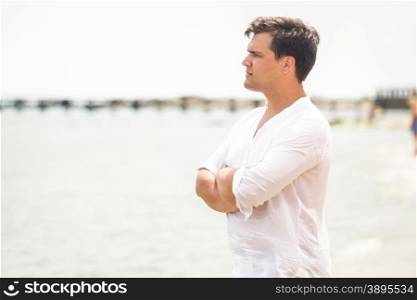 Portrait of handsome young man looking on the horizon at sea