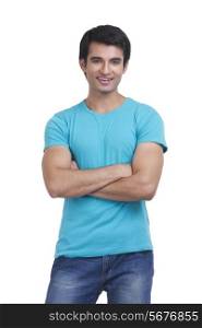 Portrait of handsome young man standing arms crossed on white background