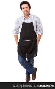 Portrait of handsome young man with apron against white background