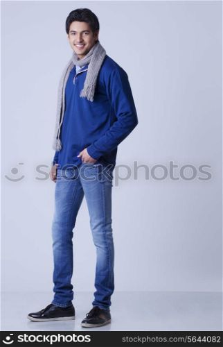 Portrait of handsome young man with hands in pockets