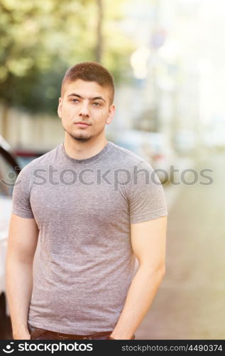 Portrait of handsome young muscular man in urban context