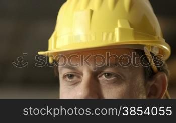 Portrait of happy adult man working as engineer with hardhat. Slow motion