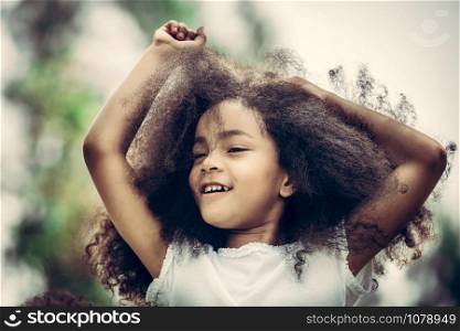 Portrait of happy African American child playing in outdoors park. Freedom and children health concept.