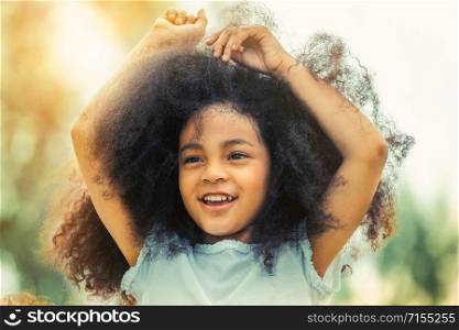 Portrait of happy African American child playing in outdoors park. Freedom and children health concept.