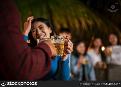 Portrait of Happy Asian friends having dinner party together - Young people toasting beer glasses dinner outdoor  - People, food, drink lifestyle, new year celebration concept.