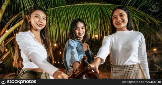 Portrait of Happy Asian friends having dinner party together - Young people toasting beer glasses dinner outdoor  - People, food, drink lifestyle, new year celebration concept.