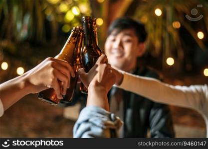 Portrait of Happy Asian friends having dinner party together - Young people sitting at bar table toasting beer glasses dinner outdoor  - People, food, drink lifestyle, new year celebration concept.